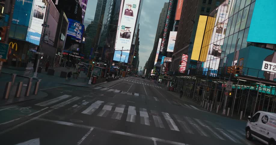 Traveling down a city street at night surrounded by buildings and flashing signs