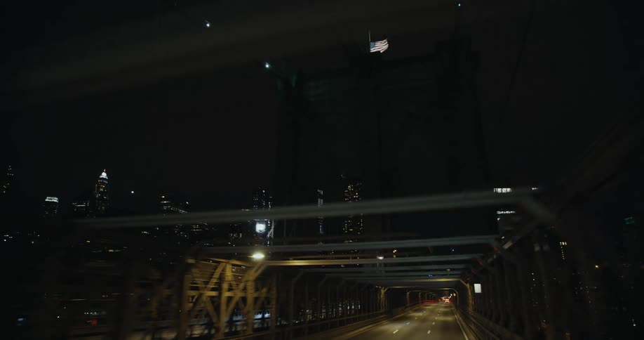 A partially covered bridge leads to a downtown city