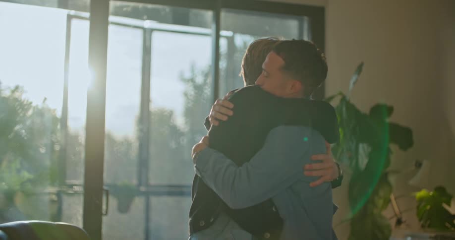 Two men hug and one leaves