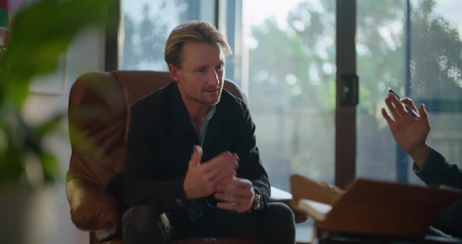 Two men are talking in the room
