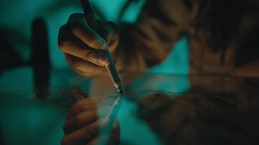 A person is drawing on the surface
