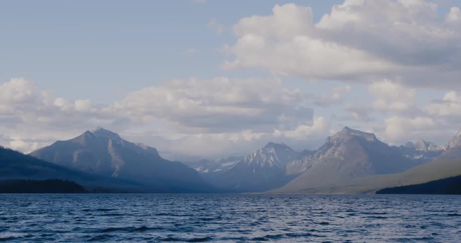 View of body of water and distant high mountains