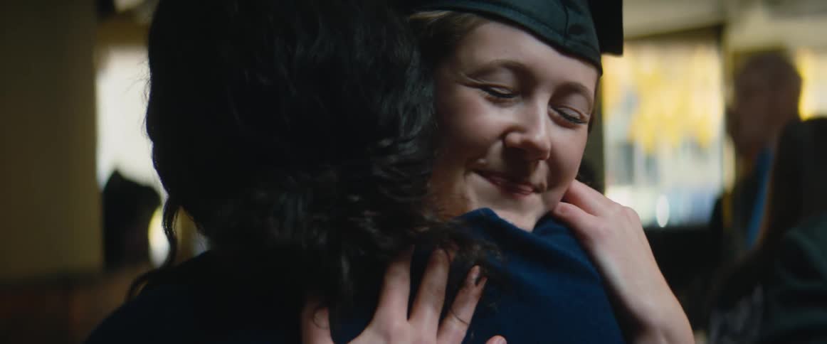 A graduate hugs someone at the ceremony