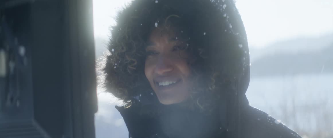 A woman is outdoors during a snow storm