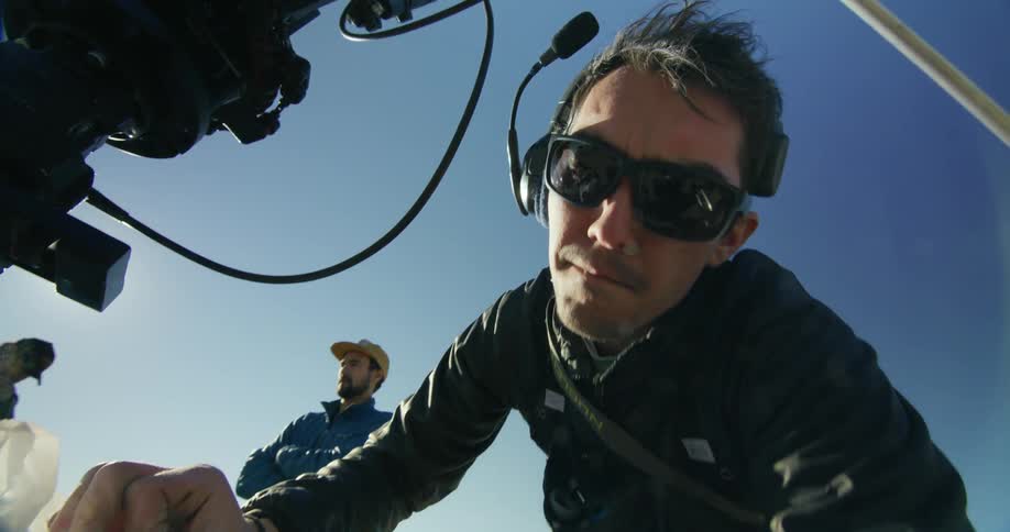 A view of a man setting up a camera