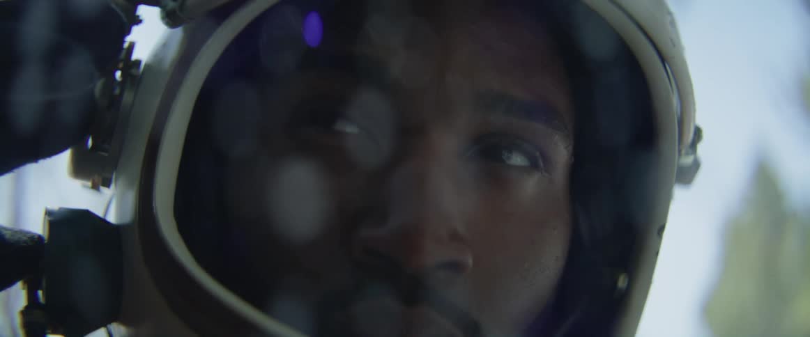 The astronaut opens his helmet