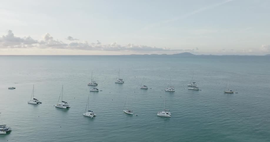 Aerial view of boats in ocean water is displayed