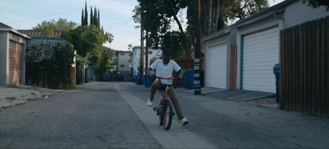 A child getting on a bicycle