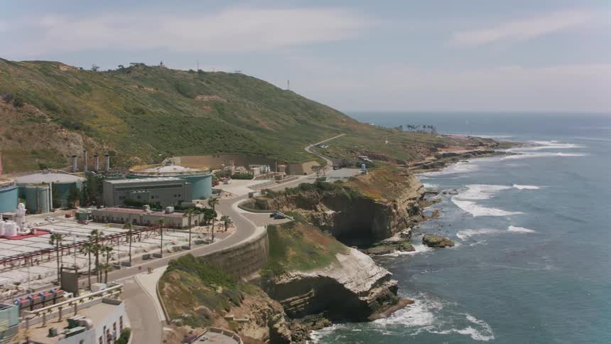 An aerial view of a factory on the shore