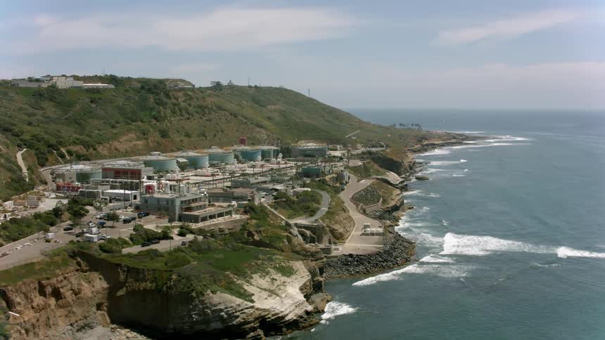 Aerial view of housing near the ocean coast is displayed