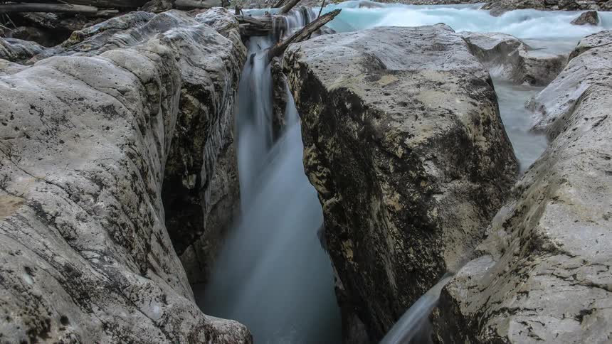 Stream water flows through rocks and boulders