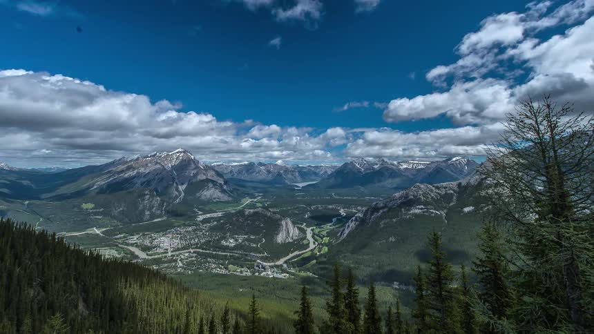Clouds pass over mountains and trees