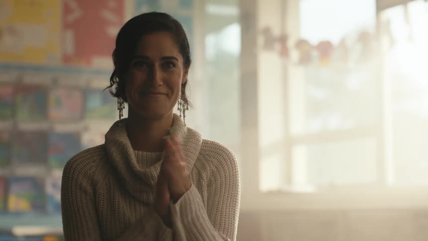 A woman smiles and claps