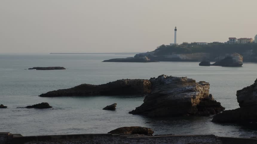 A lighthouse is on the shore