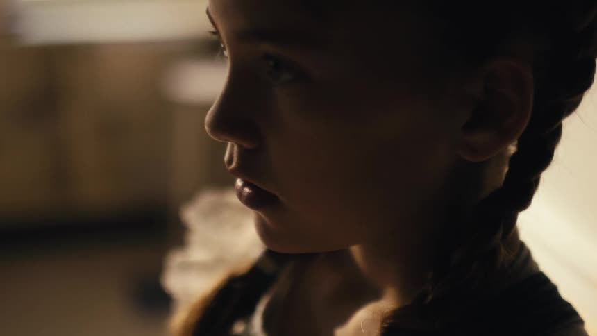 A girl is standing in a room in a house