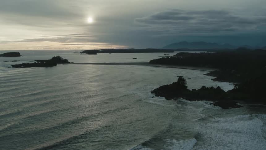An aerial view of waves in the ocean rolling in to the shore
