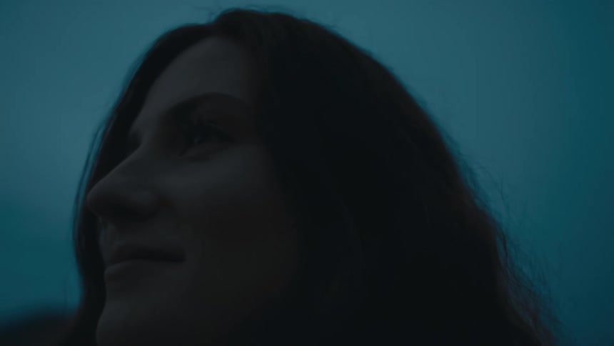 A woman is smiling outside