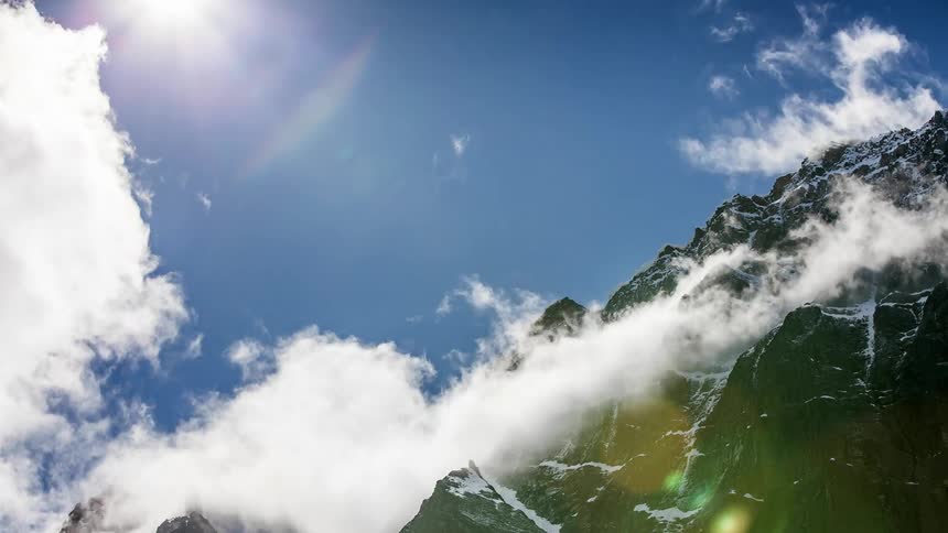 Clouds move around and change form on a mountain
