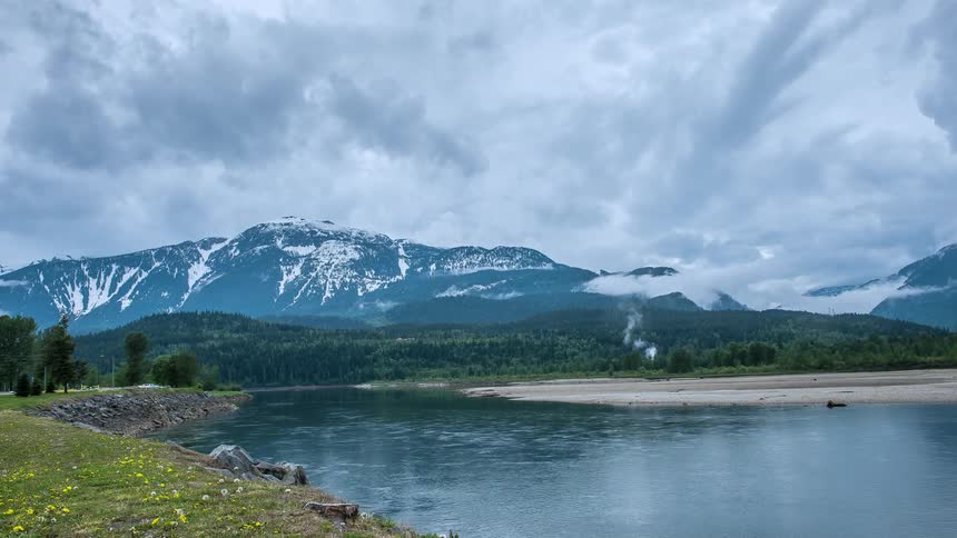 A lake at the base of a snowy mountain