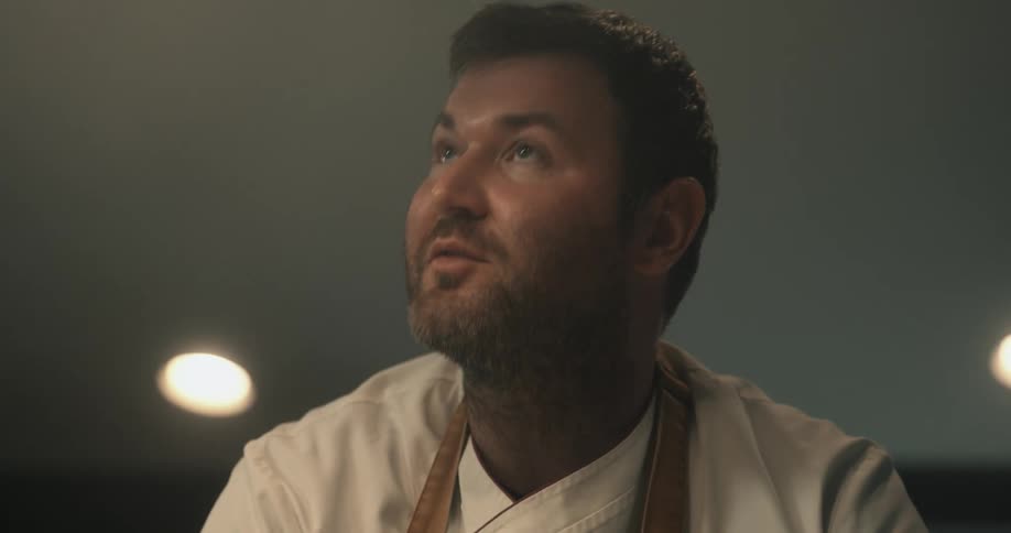 A man having a conversation while cooking
