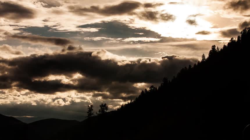 Clouds flying by near sunset