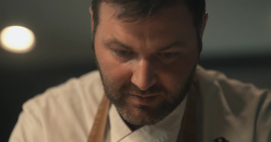 A chef is concentrating in the kitchen