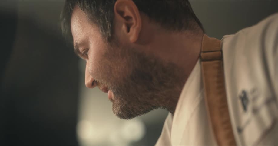 A chef smiles while cooking