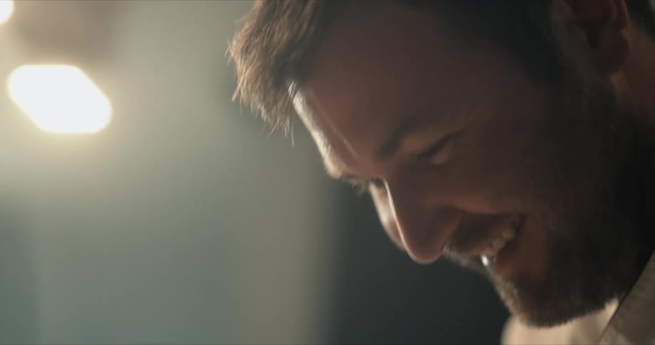 A man smiling standing in a room