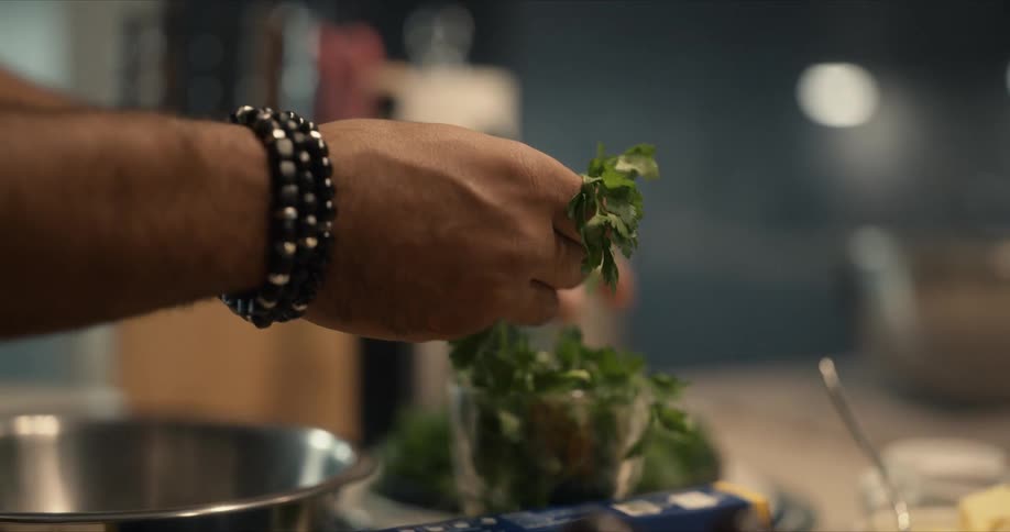 A person is breaking up parsley