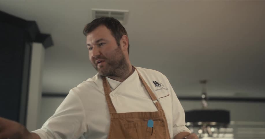 A chef is working in the kitchen