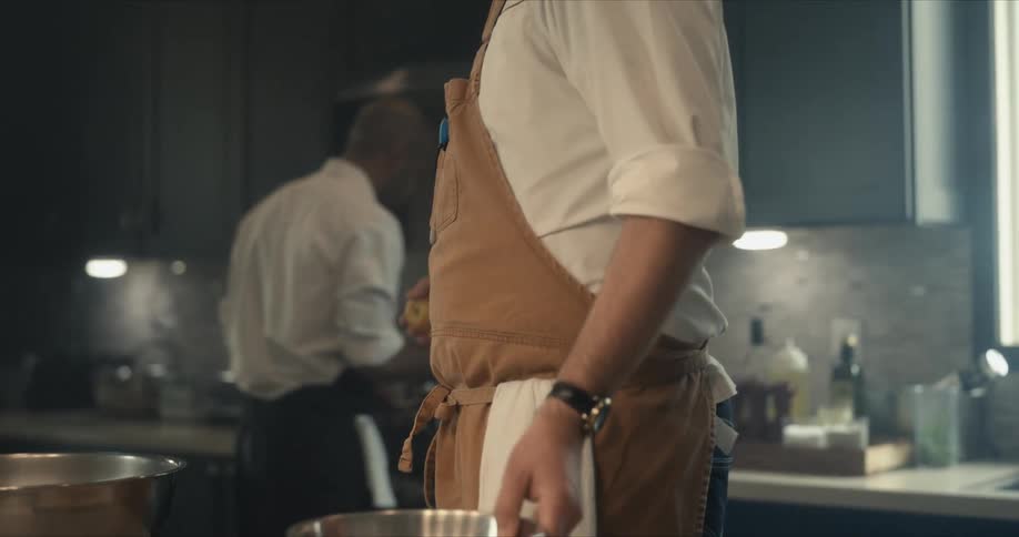 A view of two people cooking in a kitchen