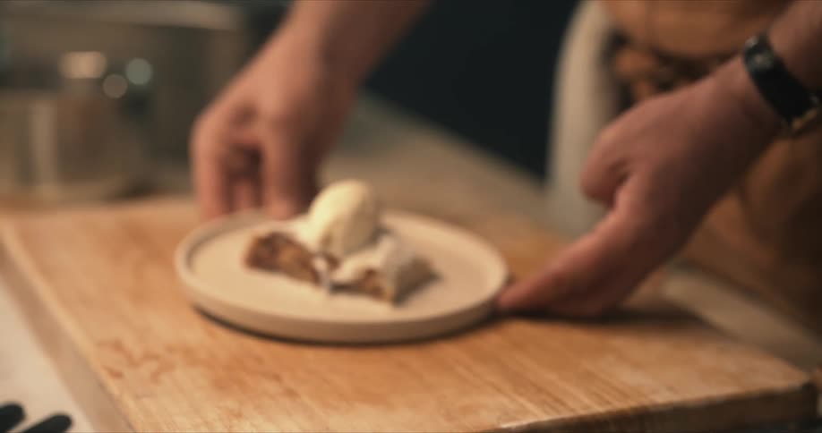 A chef displays a dessert