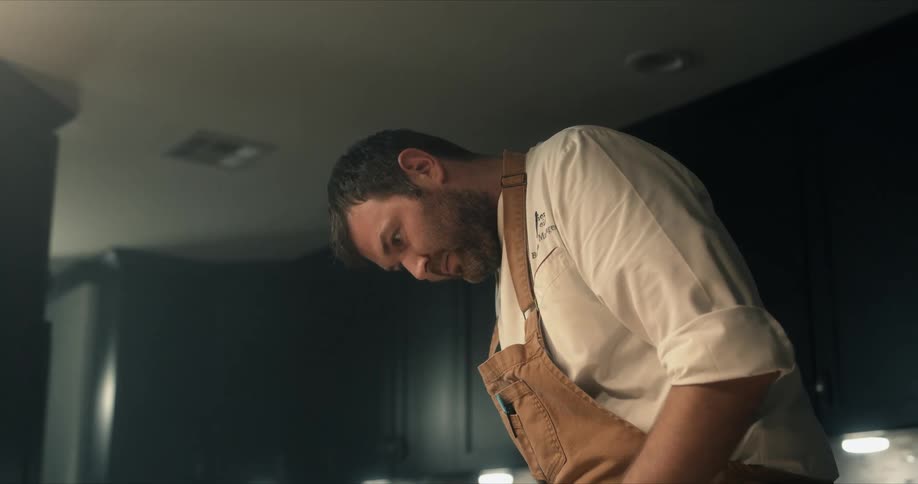 A chef is cooking in the kitchen