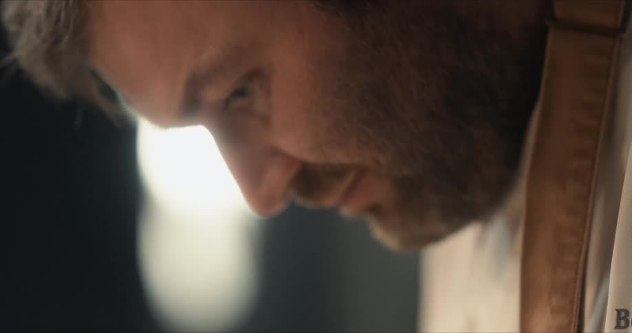 Bearded chef wears apron while working