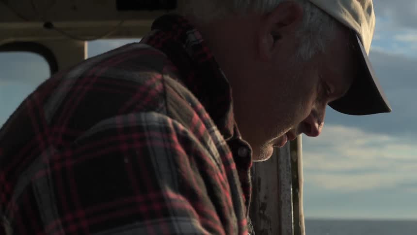 A man stands on a boat