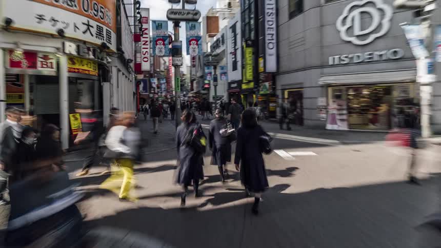 Time lapse view of people walking through a downtown city