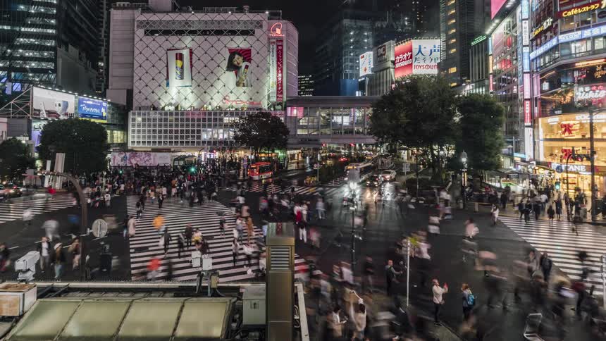 Pedestrians and vehicles travel though the intersection
