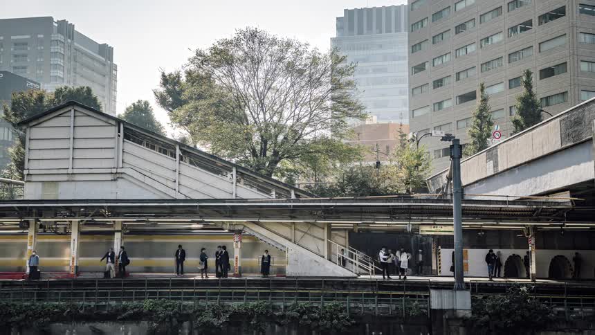 People wait for and enter the train