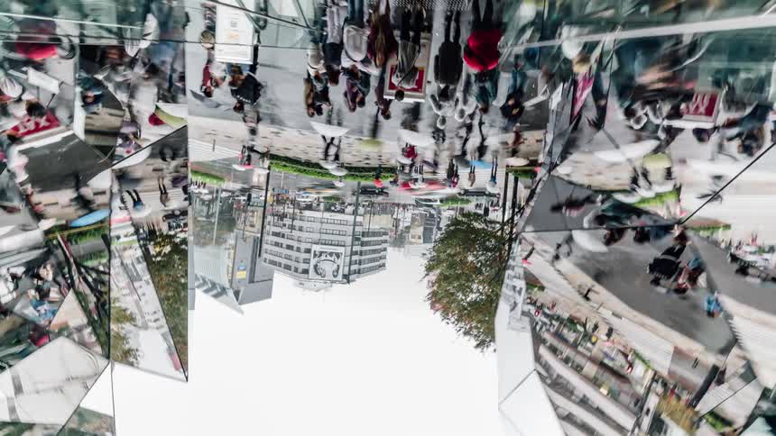 People walk through a busy city