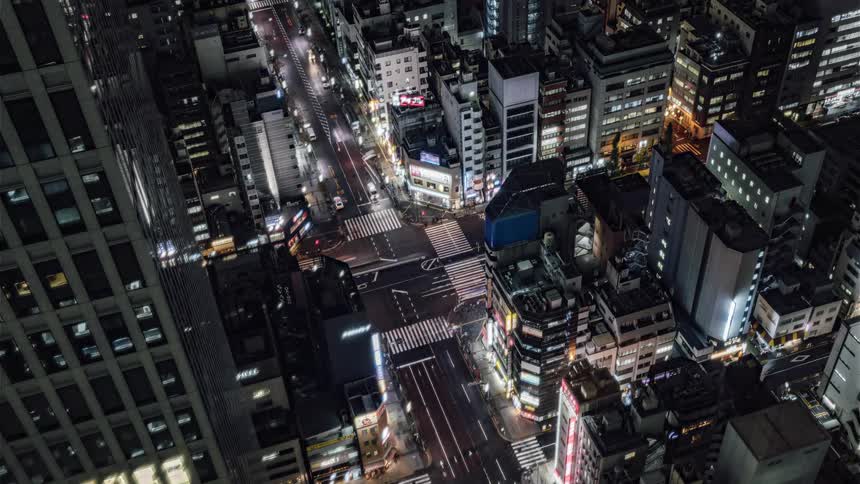 Aerial view of a downtown city at night is displayed