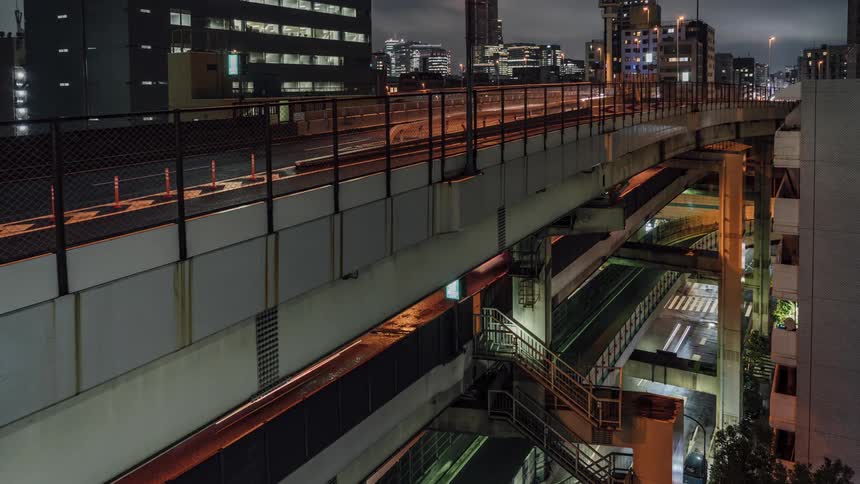 Traffic travels along the roads of a multilayered overpass in a metropolis at night