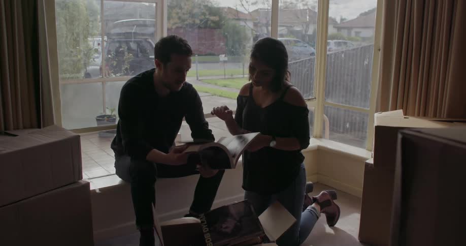 A man and woman unpack boxes