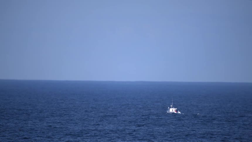 A boat floats out to sea
