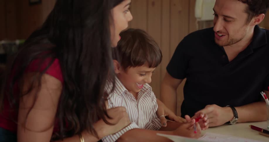 A mother, father and child laugh together