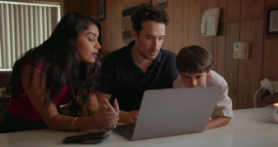 Man woman and child talk about what is on a laptop screen in their house