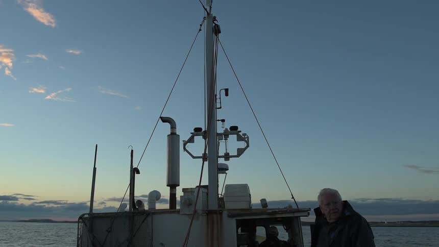 A man sits on a boat