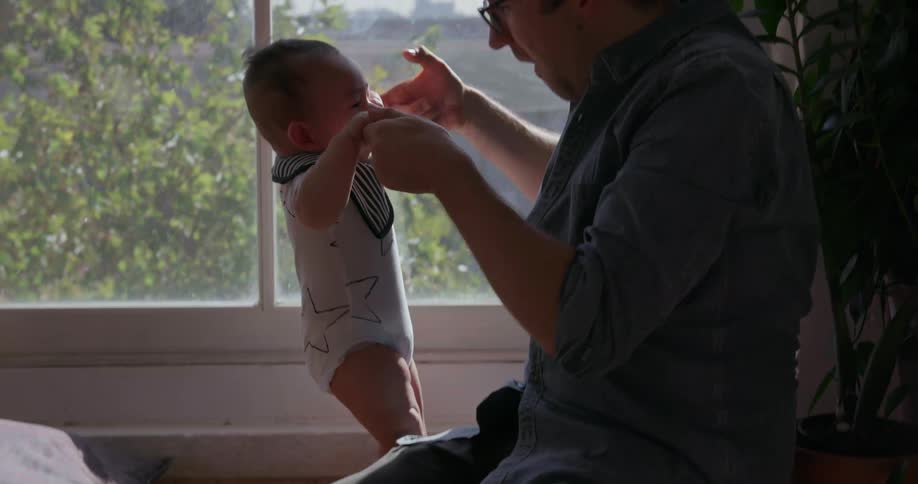Man plays with infant