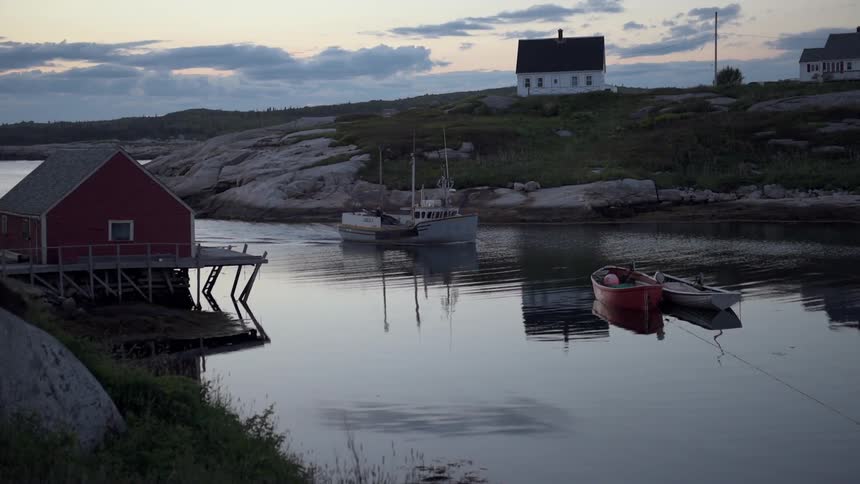 Boats float on a small river at sunset