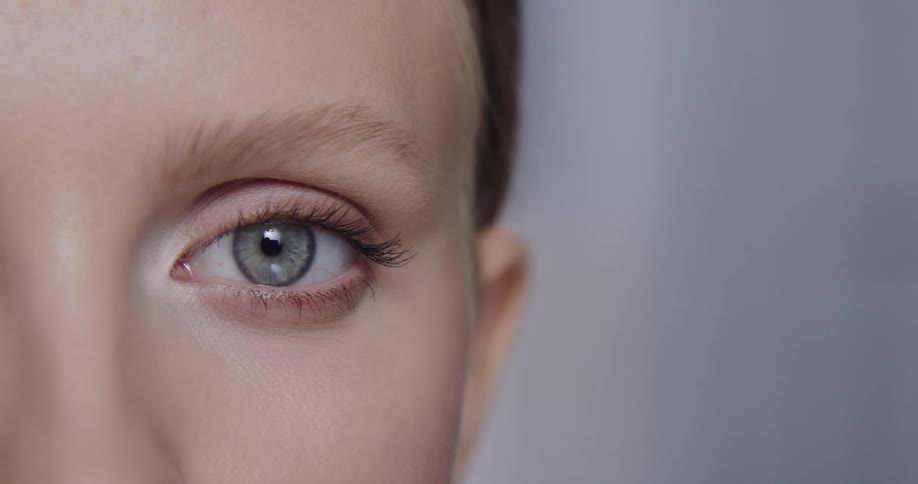A woman blinks while posing in a brightly lit room