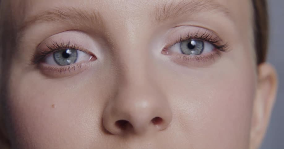A model tilts her head while posing indoors